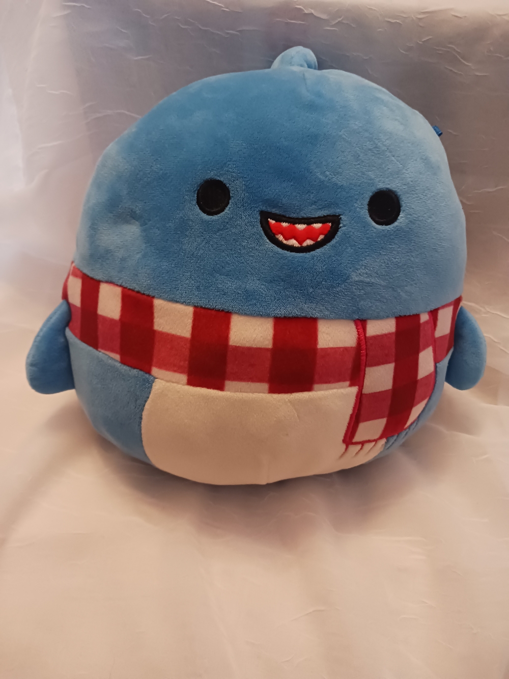 Squishmallows Blue Whale Plush with Red Check Scarf named Rey.